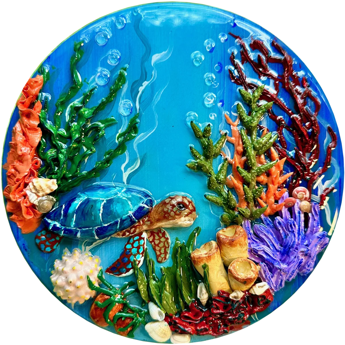 Round panel of a sculpted sea turtle swimming through coral, seaweed and shells